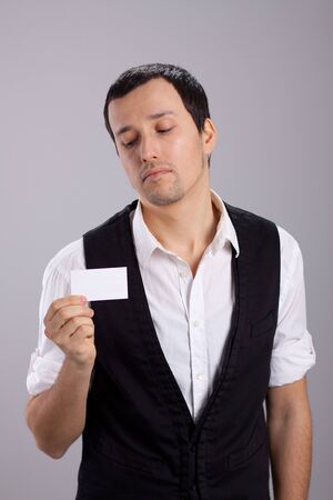 young guy with a business card in his handの写真素材