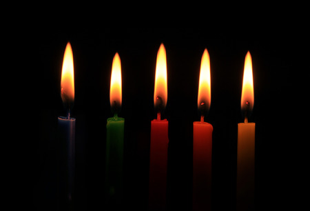 burning five colors candles in a rowの写真素材