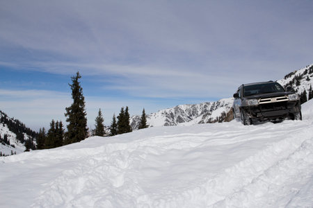 Off-Road SUV Buried in Deep Mountain Snow During Winter Expedition