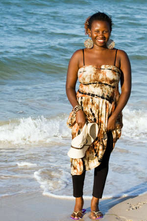 Uganda woman enjoys the beach in Tanzaniaの写真素材