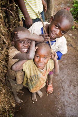 KISORO, UGANDA - DECEMBER 31, 2013  Portrait of unidentified pygmy children smile into the camera and make fun のeditorial素材