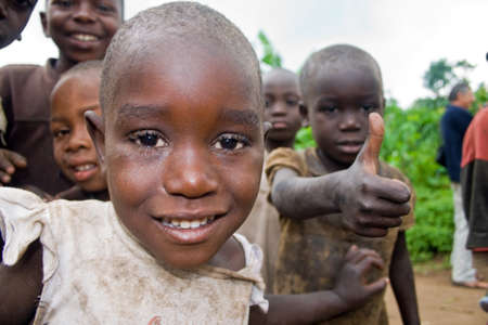 KISORO, UGANDA - DECEMBER 31, 2013  Portrait of an unidentified pygmy child with other unidentified...