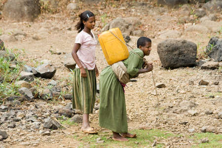 BARHIR DAR, ETHIOPIA - FEBRUARY 26, 2010: Two unidentified women collect water from Lake  Tana in Ethiopia.のeditorial素材
