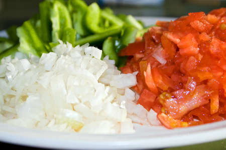 Close up of chopped tomatoes, pepper and onions.の写真素材