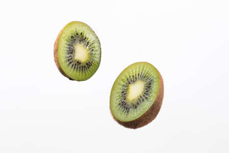 sliced kiwi isolated on white background.の写真素材