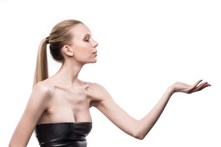 the girl holds blank space over a hand on a white background.の写真素材