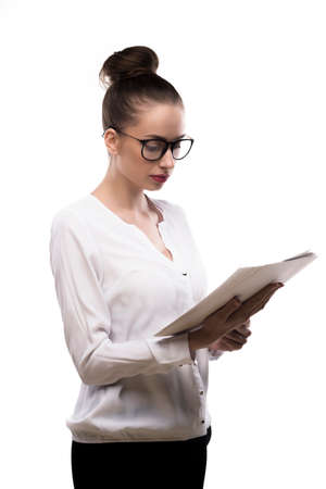 office girl in glasses holds papers in hands isolated on white.の写真素材