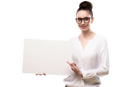 office girl holds in hands blank white plate on a white background.の写真素材