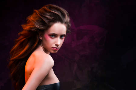 the girl with a vanguard make-up and a hairstyle on a violet background.の写真素材