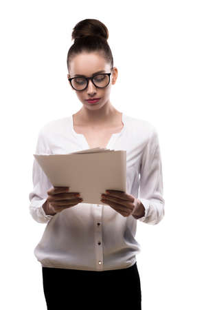 office girl in glasses holds papers in hands isolated on white.の写真素材