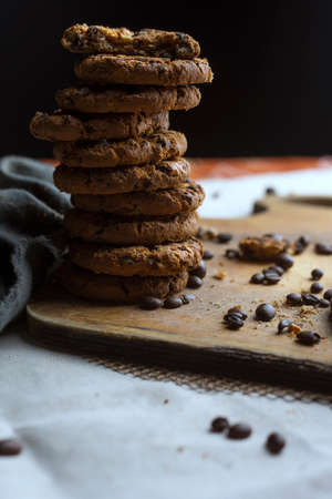macro still life from cookies of cakes and coffee beans on a wooden board