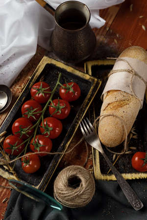 still life. Cezve, cherry tomato branch, bread, fork.の写真素材