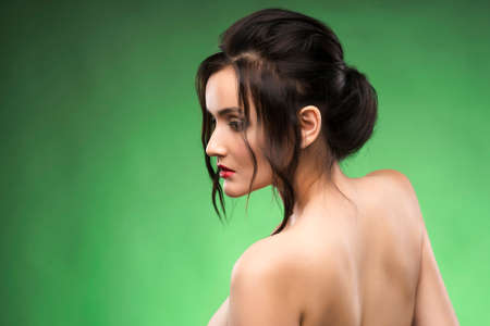 Beautiful mature woman portrait on green ñhromakey background. Healthy clear skin.