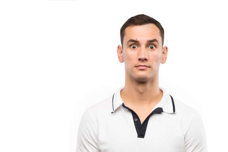 The puzzled young man isolated on a white background. Copy spaceの写真素材
