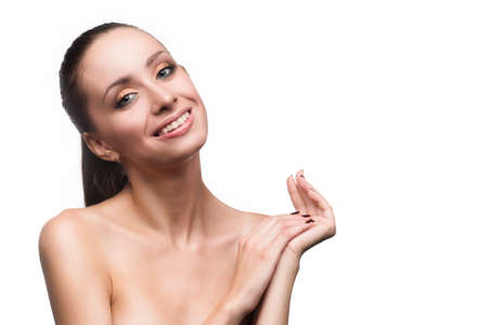Portrait of beautiful young woman with clean, fresh skin smiles broadly isolated white background. Cosmetology, beauty, spa, dentistry, stomatology. Copy spaceの写真素材