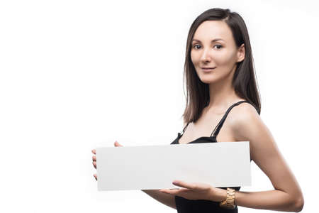 The beautiful mixed asian-caucasian race girl  holds in hand the empty white plate isolated on a white background. Natural make-up. Ñopy space. Healthy clear skin.の写真素材