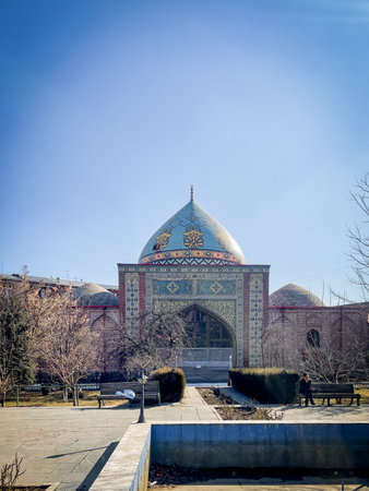 Historic Persian mosque in Erevan Armenia with intricate tilework, golden dome, and archway,...