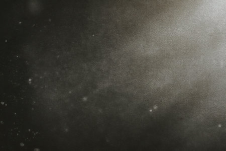 Subtle charcoal film grain texture with vintage noise, moody shadows, and faded lighting perfect for cinematic backgrounds and analog-inspired overlaysの素材