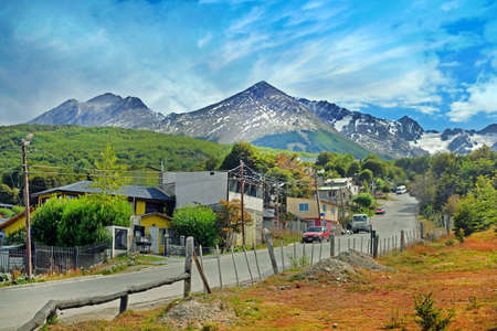 Panoramic view of the city of Ushuaia and the snowy Martial mountain range against a clouded sky.の写真素材