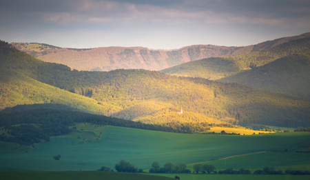 Spring mountain hills. Green valley and mountain forest in morning sunlight.の写真素材
