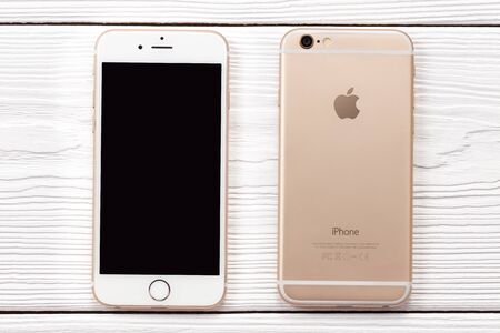 New York, USA - March 27, 2018: Iphone smartphone front and back side on wooden background. Iphone...