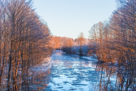 Spring river. Sunny spring morning on river full of water.の写真素材