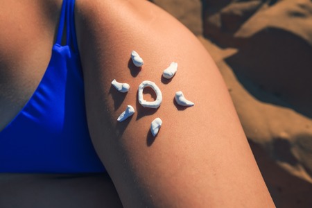 Sun cream on a girl's leg close-up. Sunscreen protection concept.