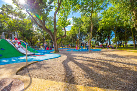 Rimini, Italy - June 14, 2018: Outdoor children playground in Rimini with green trees on a sunny day.のeditorial素材