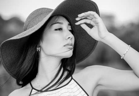 Close up portrait of young woman in wide hatの写真素材