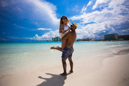 Honeymoon romantic lovers vacation on a tropical beach. Young happy lovers on romantic travel honeymoon having fun on vacation summer holidays romance.の写真素材