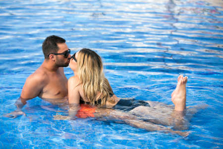 Honeymoon romantic lovers vacation on a tropical beach. Young happy lovers on romantic travel honeymoon having fun on vacation summer holidays romance.の写真素材