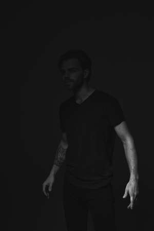 Portrait of a man in a dark key in the studioの写真素材