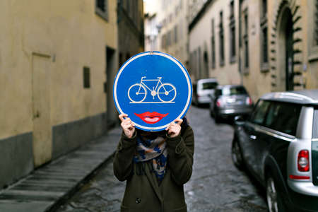 road sign with a bicycle and lips in the faceの写真素材