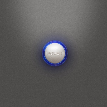 Illuminated power button on the front PC board on a gray backgroundの写真素材