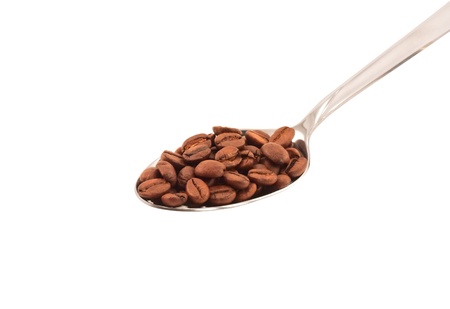 Metal spoon with coffee beans top view isolatedの写真素材