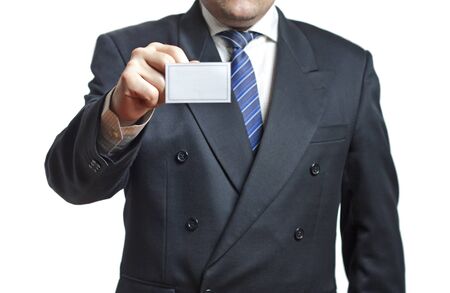 Businessman in a black suit holding a blank card in the hand isolated on white backgroundの写真素材
