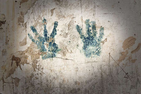 Texture of the old worn beige wall with handprint and frame