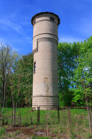 Brick water tower in the forest verticalの写真素材