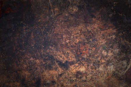 Dark worn wooden surface with scratches and spotsの写真素材
