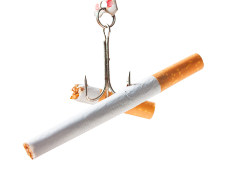 Bad habits. Cigarettes on a hook isolated on white background. Studio shot. Quitting smokingの写真素材