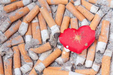 Wounded heart on cigarette bulls. Stop smoking nowの写真素材