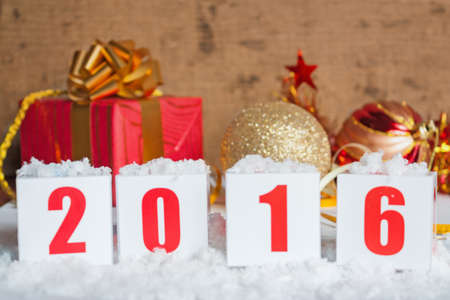 Greeting card 2016 with New Year gifts and snow