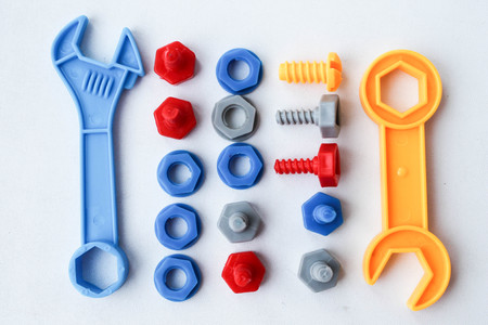 Children's plastic multi-colored toy bolts and nuts. A set of construction hardware for children.の写真素材
