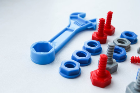 Children's plastic multi-colored toy bolts and nuts. A set of construction hardware for children.の写真素材