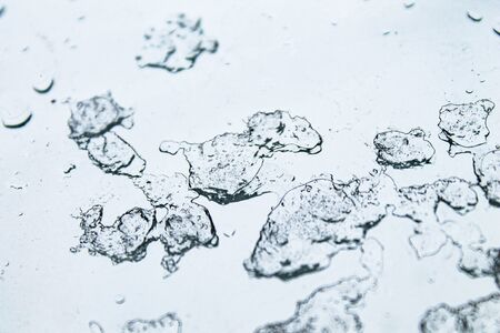 Snow on the window. Frozen and melted snow on the glass.