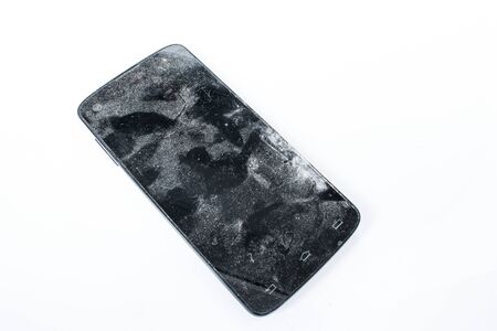 Old broken mobile phone on a white background.の写真素材