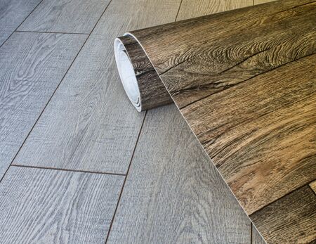 Roll of linoleum with a wood texture. Types of floor coverings. PVC.の写真素材