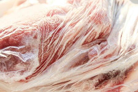 Frozen meat in a plastic bag.