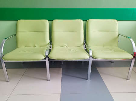 Chairs in the hallway for waiting. Waiting room. Empty chairs in the reception area.の写真素材