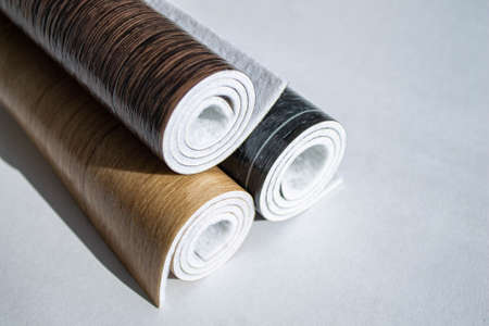 Linoleum. Three rolls of linoleum on a white background. Floor coverings for home use. Linoleum...